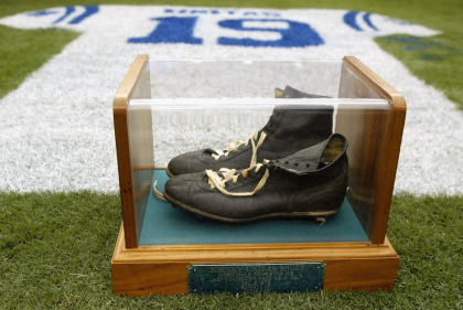 BALTIMORE - SEPTEMBER  15:  Detail of an onfield tribute to Hall of Fame quarterback Johnny Unitas #19 of the Baltimore Colts with his signature black high tops in a glass case during halftime of the NFL game between the Tampa Bay Buccaneers and the Baltimore Ravens on September 15, 2002 at Ravens Stadium in Baltimore, Maryland. The Buccaneers shut out the Ravens 25-0.  (Photo By Scott Halleran/Getty Images)